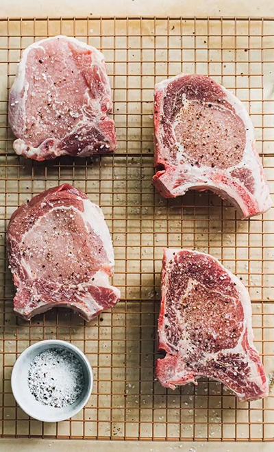 Grilled bone-in pork chops with garlic butter